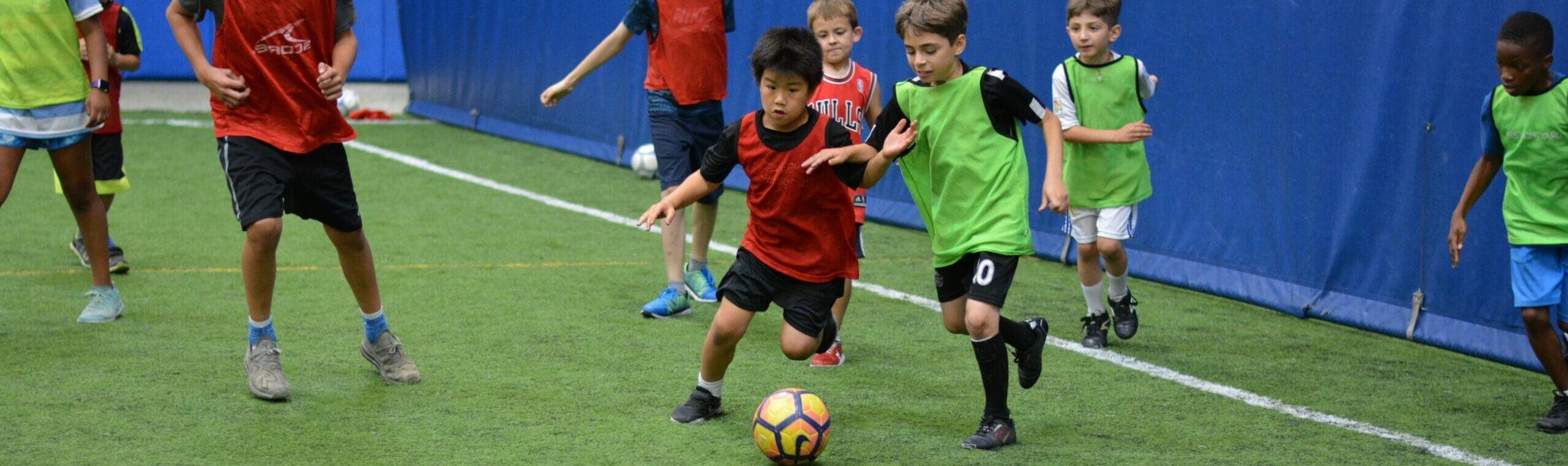 Kids practicing soccer drills during skills training session at Milwaukee Yard indoor turf field
