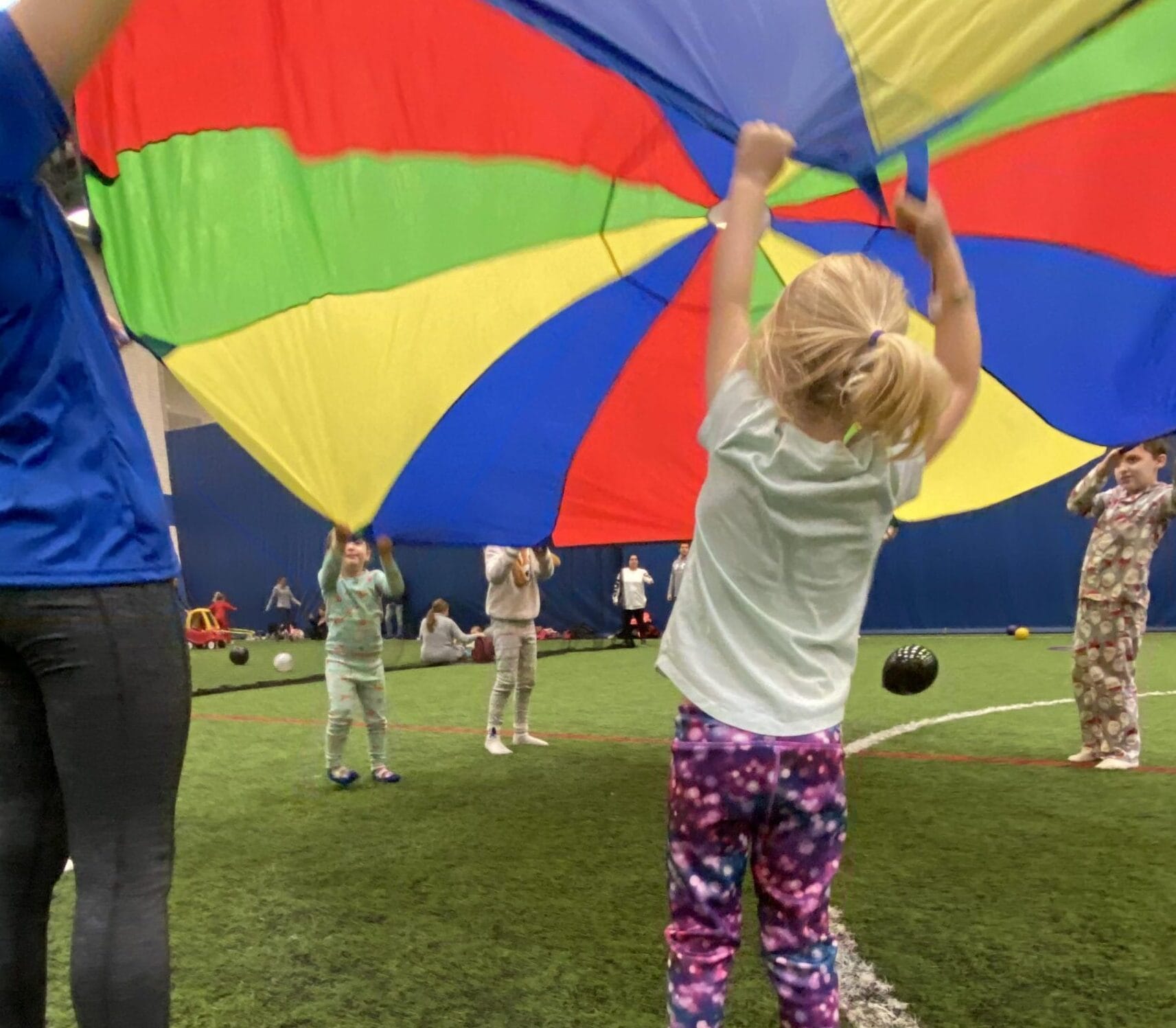 New Years Eve Pajama Party Participant plays with a parachute at Milwaukee Yard Oak Creek Wi