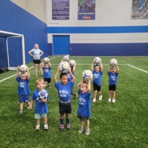 Children ages 2 to 6 playing soccer games during Mighty Tykes class at Milwaukee Yard