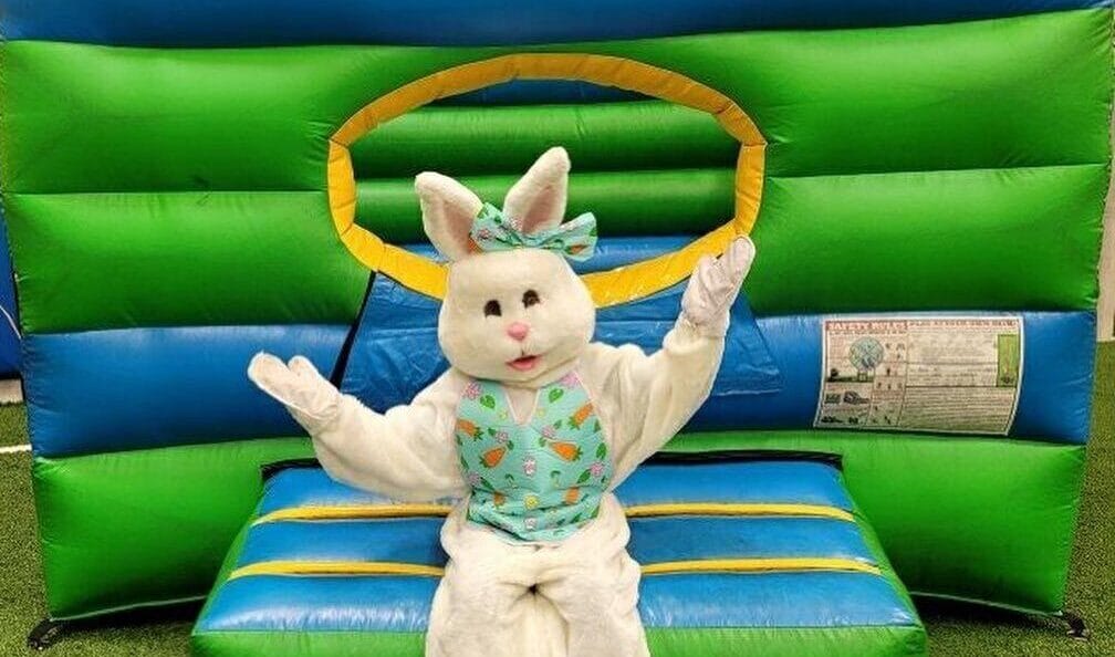 Easter Bunny sitting on an inflatable on indoor turf fields at Milwaukee Yard Oak Creek WI