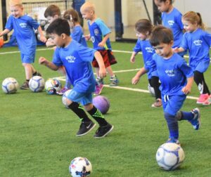 Toddlers playing on indoor turf field during Active Childcare at Milwaukee Yard in Oak Creek WI, Mighty Tykes discounted class