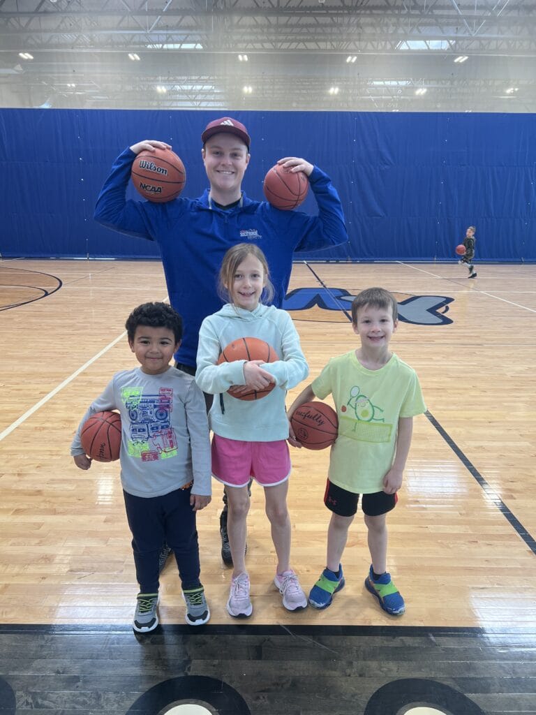 coach with kids in summer basketball camp at milwaukee yard