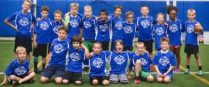 Young athletes in blue shirts at Milwaukee Yard youth football program