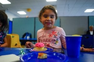 Child in private birthday party room eating cake at Milwaukee Yard Oak Creek