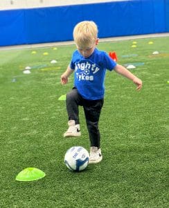 Toddler learning soccer skills at Mighty Tykes at Milwaukee Yard Oak Creek WI