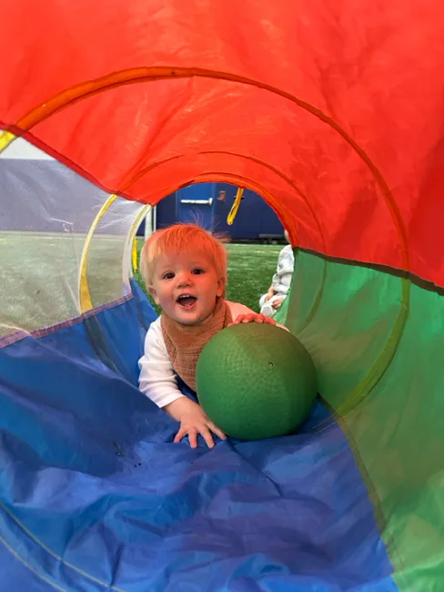 Toddlers playing on indoor turf field during Active Childcare at Milwaukee Yard in Oak Creek WI