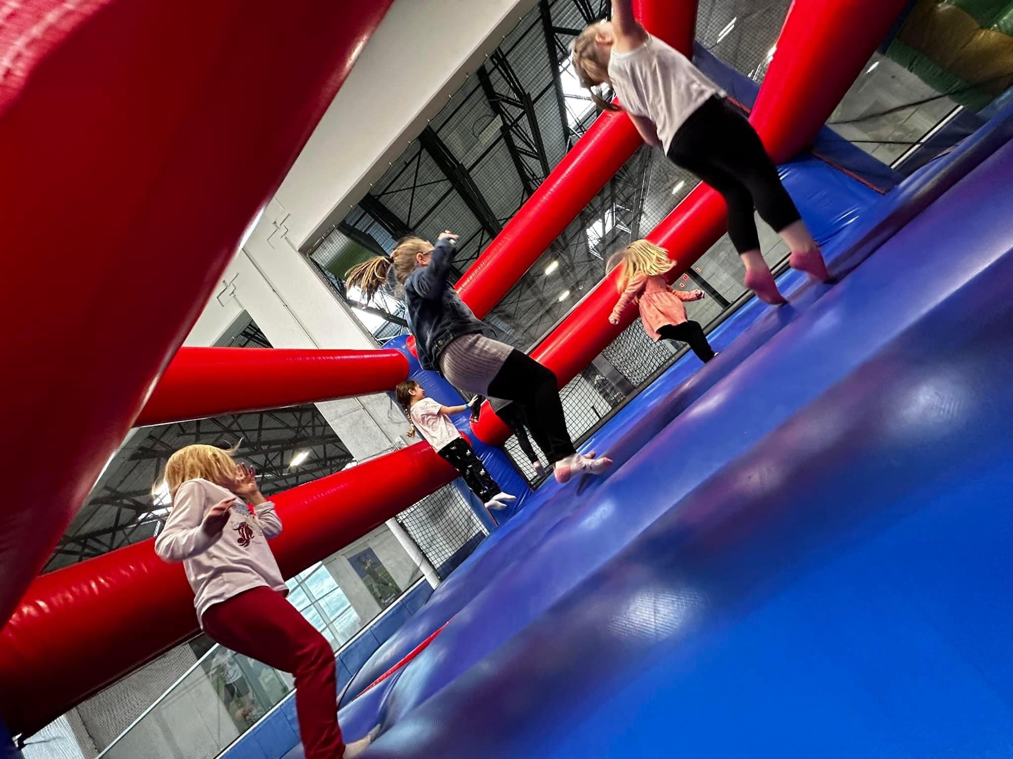Kids jumping in inflatable bounce houses during The Playroom at Milwaukee Yard Oak Creek WI