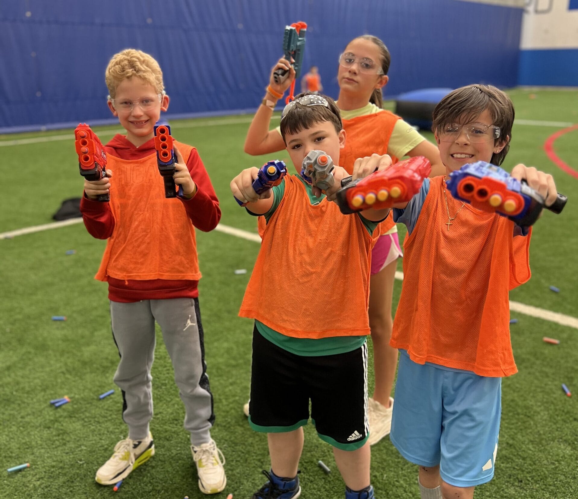 Kids playing NERF on indoor turf during birthday party at Milwaukee Yard