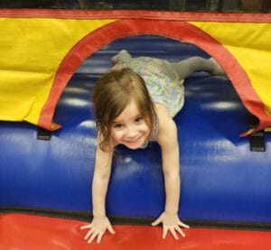 Children bouncing on inflatables during indoor birthday party at Milwaukee Yard Oak Creek WI
