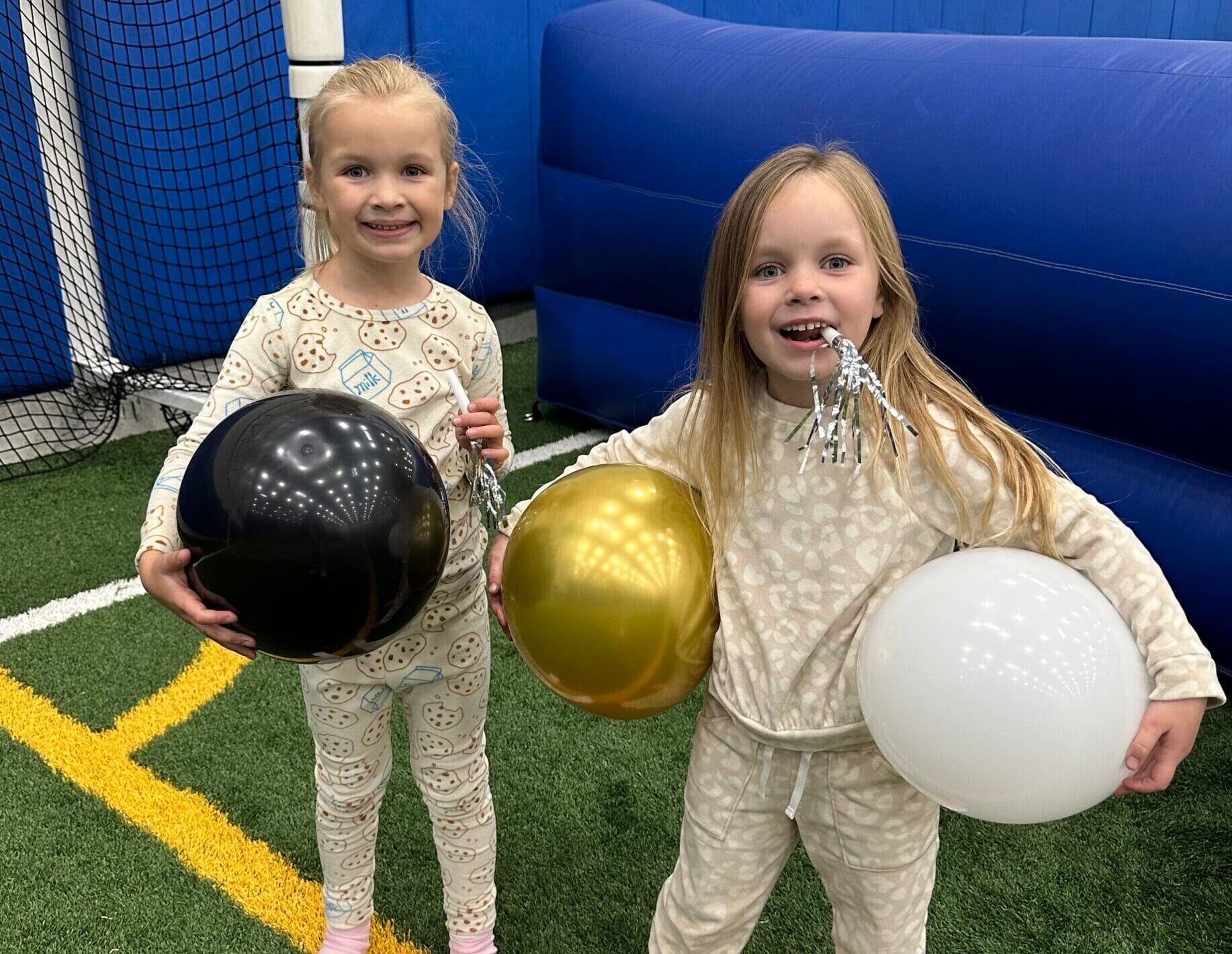 New Years Eve Pajama Party Participants holding balloons from balloon drop at Milwaukee Yard Oak Creek WI